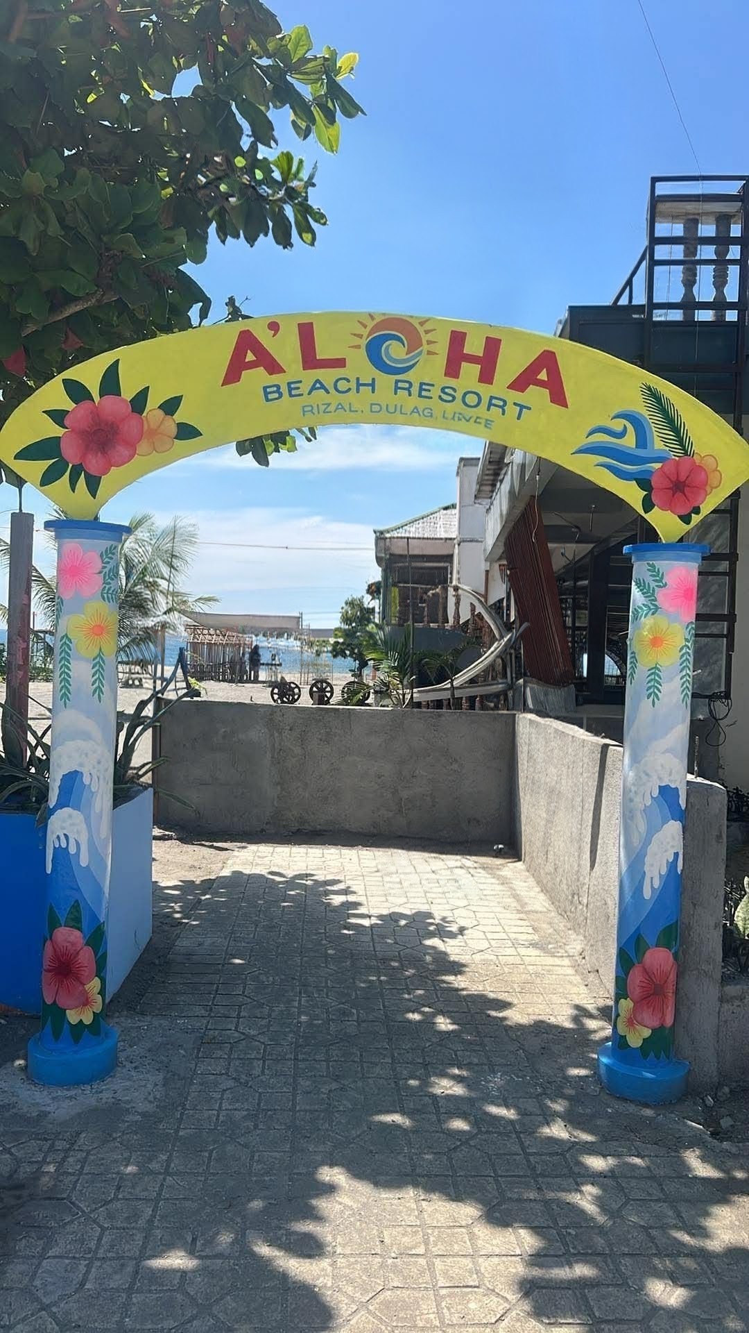 Colorful Aloha Beach Resort entrance signage